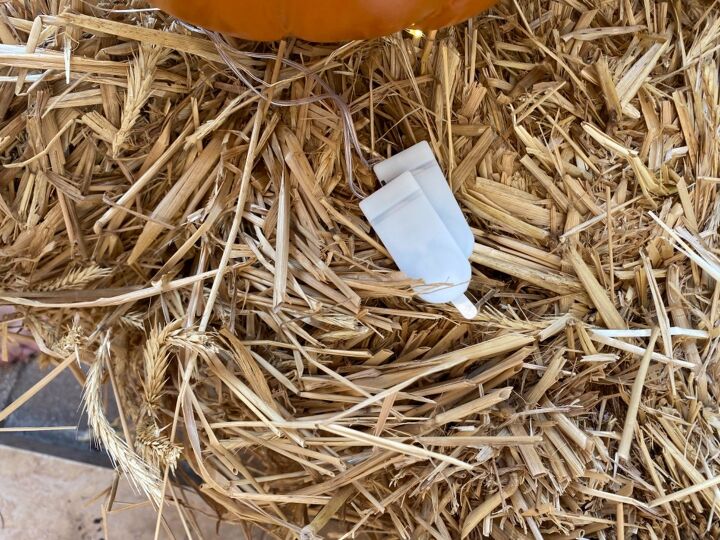 fall door decor using hay bales and fairy lights