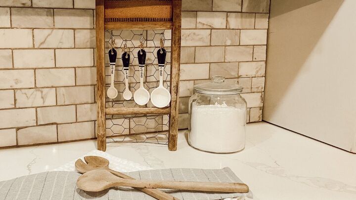 s 18 inexpensive ways to make your kitchen prettier and more organized, Hang your measuring spoons on a washboard