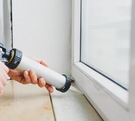 how to get rid of stink bugs your complete elimination guide, Person caulking around window