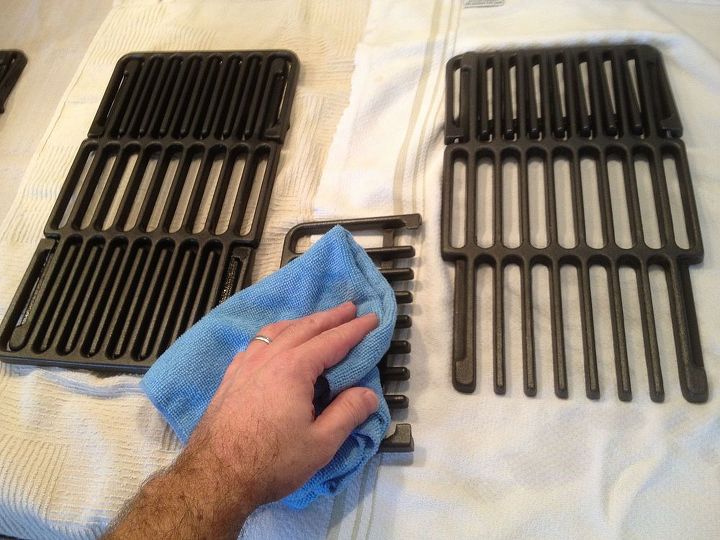 how to clean a grill for your best barbecue season yet, Using a blue towel to wipe black grill grates
