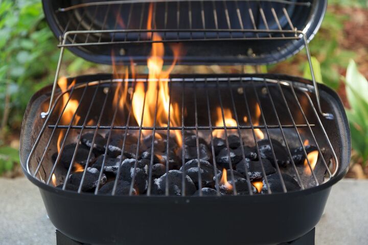 how to clean a grill for your best barbecue season yet, Lit charcoal grill