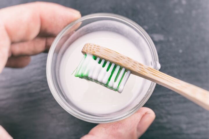 how to remove oil stains from clothes using simple pantry items, toothbrush dipped in white paste