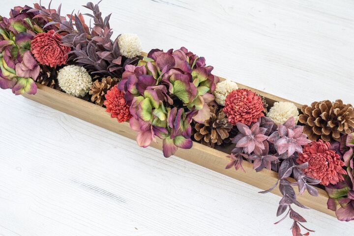 s 16 wild ways people are using pine cones this season, A gorgeous floral centerpiece