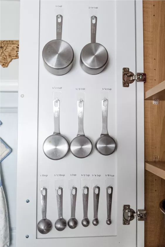 a step by step guide on how to organize kitchen cabinets, How to store measuring spoons and cups