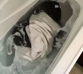 how to strip your laundry which is dirtier than you think, Dirty laundry in water filled bathtub