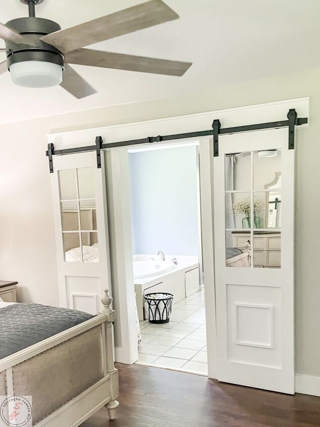 s 15 showstopping ideas that ll make guests gather in your bathroom, Add a mirrored sliding barn door
