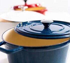 how to clean enameled cast iron, a blue enameled cast iron dutch oven with a white one and a red one behind it