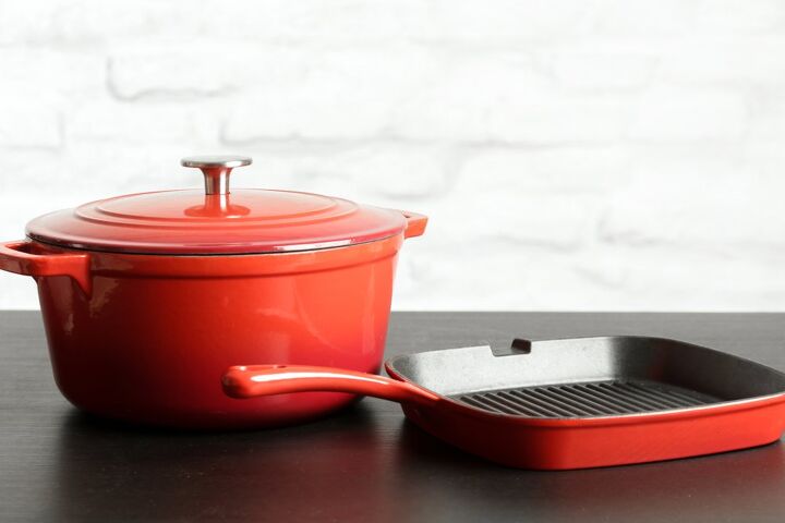 how to clean enameled cast iron, two red enameled cast iron cookware pieces