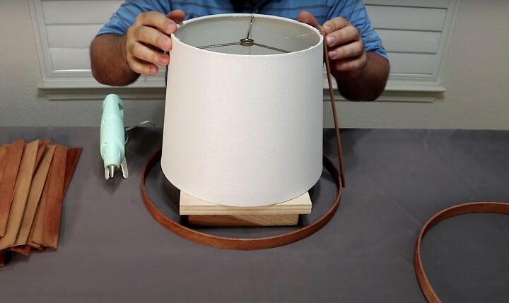 how to make a simple but beautiful paint stick lamp, Start gluing the paint stirrers to the hoop