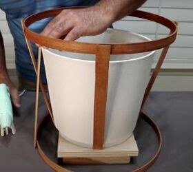 how to make a simple but beautiful paint stick lamp, Glue stirrers from inside the top hoop