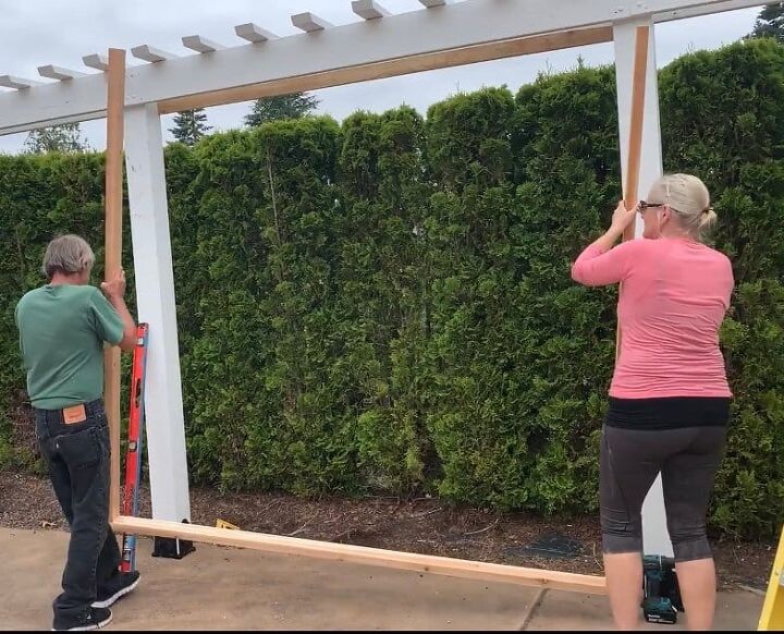how to create a lattice wall in your garden, We lift our frame into place making sure that it is level before we attach it
