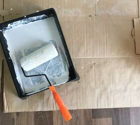 how to properly clean paint rollers and trays, paint roller and black paint tray covered in white paint