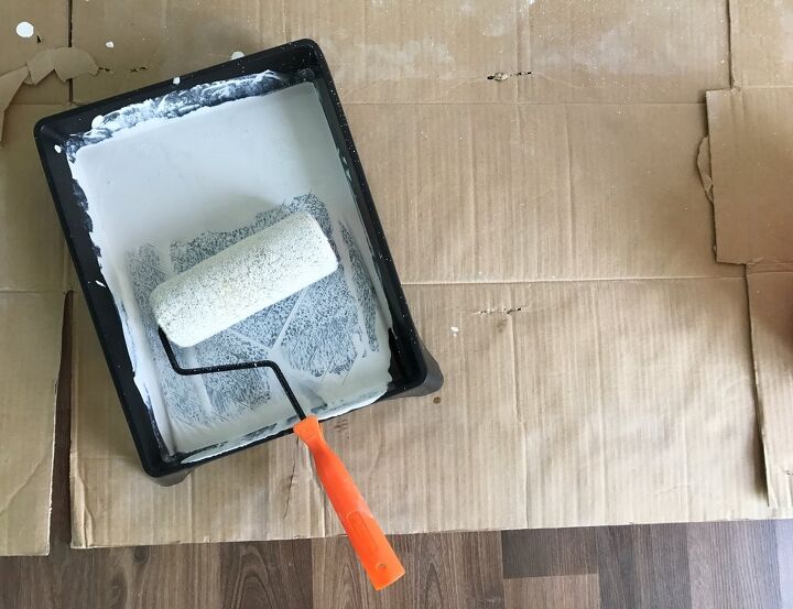 how to properly clean paint rollers and trays, paint roller and black paint tray covered in white paint