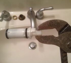 how to fix a leaky faucet before it makes a dent on your water bill, wrench holding white cartridge