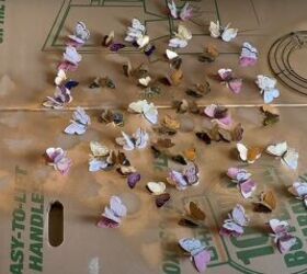 how to make a gold butterfly mirror that looks designer, Paper butterflies spread out on a cardboard box