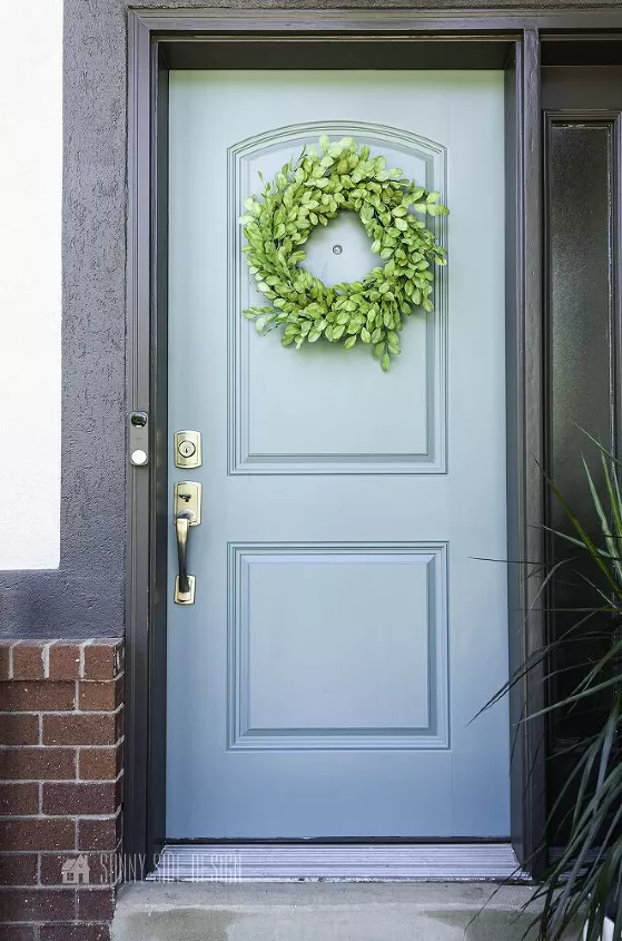 how to paint a front door, light blue front door with green wreath
