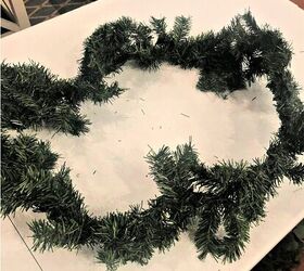 She takes a cheap evergreen garland outside and just 30 minutes later it looks amazing!