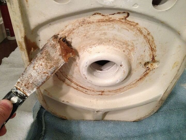 how to fix a wobbly toilet in a matter of minutes, removing the wax ring from the underside of a toilet
