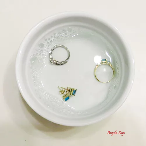 how to clean gold jewelry so it shines like new, three gold rings in a white bowl