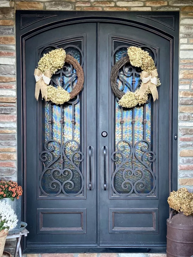how to dry hydrangeas, hydrangea grapevine wreaths displayed on iron front doors