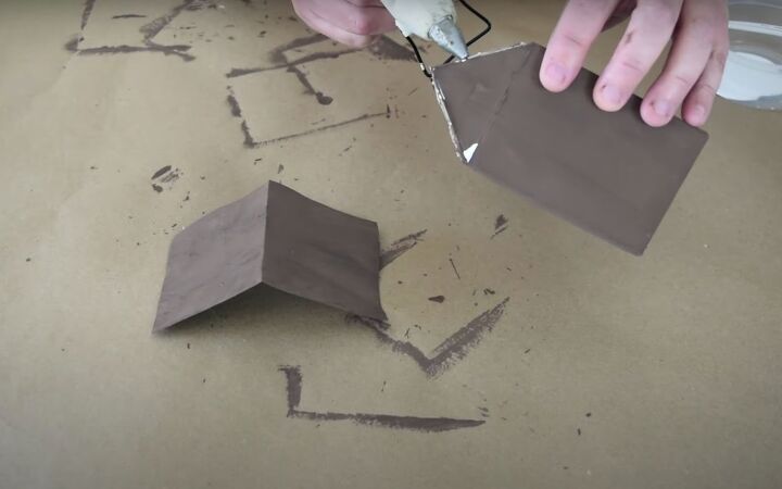 the easiest milk carton gingerbread house in a few steps, Attaching the roof piece to the milk carton with hot glue