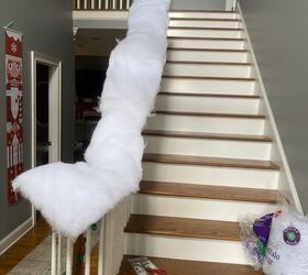 She wraps fake snow around her banister and then grabs stuffed animals for the sweetest, 30-minute decor idea