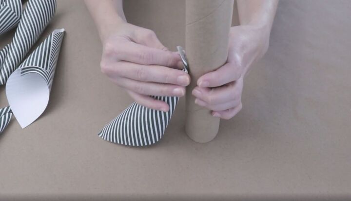 5 quick and easy steps to make a wrapping paper christmas tree, Taping the first cone onto the cardboard tube