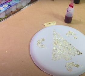 how to make an adorable tie dye paper plate ornament craft, Paper plate with stenciled gold leaf Christmas tree