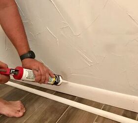 how to caulk baseboards for the cleanest lines ever, hand caulking white baseboard