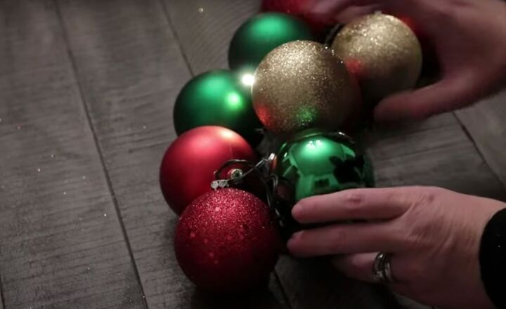 christmas decor how to make a beautiful diy ornament garland, Tucking the battery pack underneath the garland