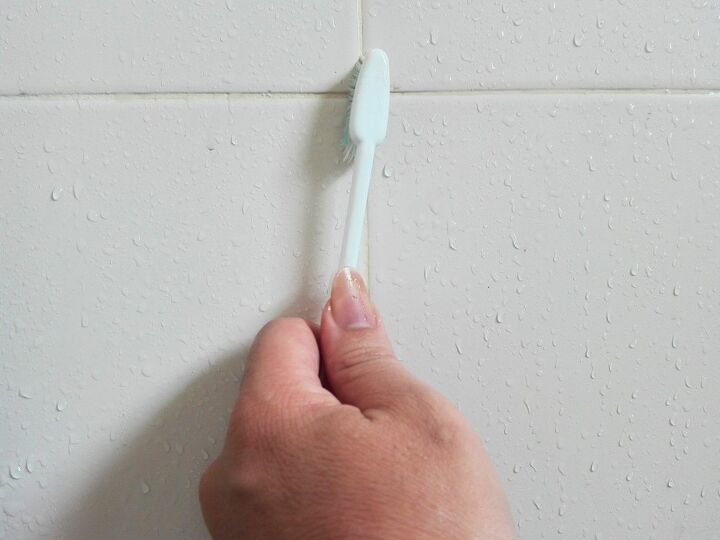 how to remove paint from tile, hand scrubbing grout with toothbrush