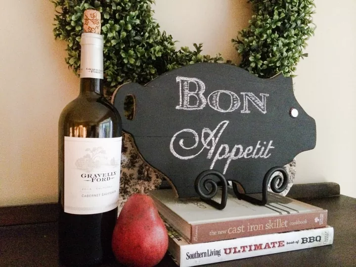 how to clean a chalkboard that s stubbornly cloudy and dusty, chalkboard next to a bottle of wine