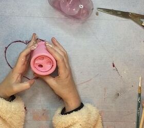 dollar tree valentine s day gumball machine makeover, hands holding pink base of gumball machine