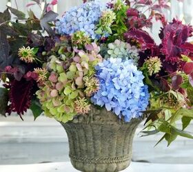 how to arrange flowers in a tall vase, flower arrangement in stone urn with hydrangeas