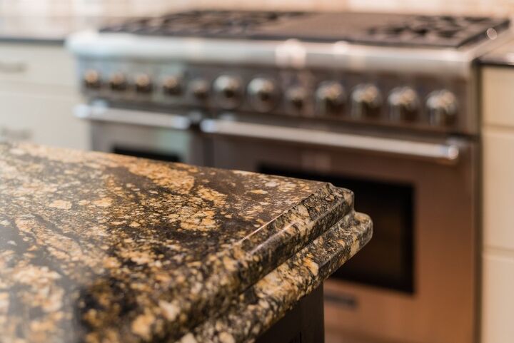 how to repair chipped granite, corner of granite countertop with stainless steel oven in background
