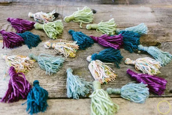 how to make tassels, different colored tassels laid on wood table