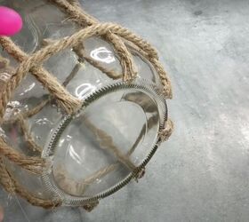 how to make a diy lantern ornament out of waste materials, Gluing a horizontal strip of rope to the bottom of a glass jar