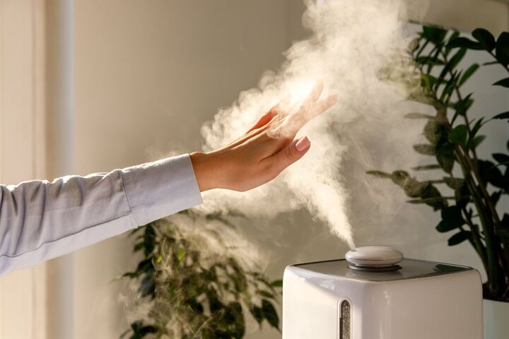 the 7 best humidifiers to get you through winter, Hand hovering over humidifier steam Photo via Shutterstock