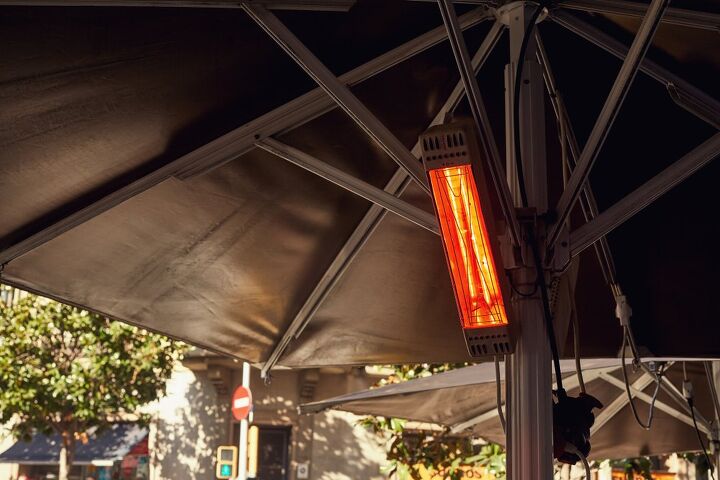electric patio heater mounted on a black umbrella / Photo via Shutterstock