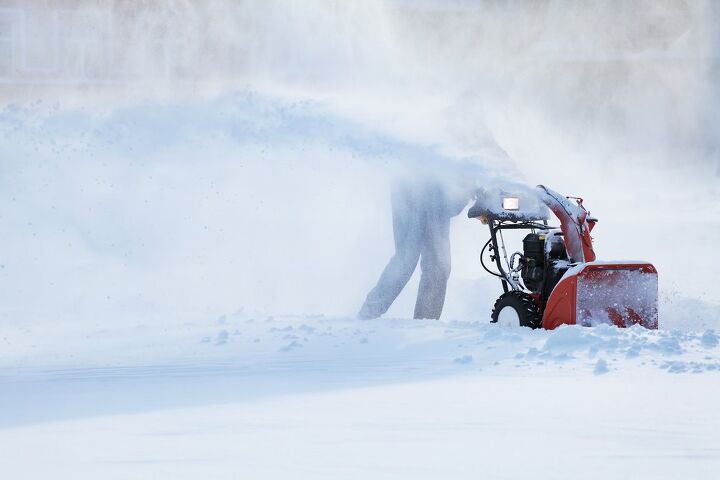Person using red snow blower / Photo via Shutterstock