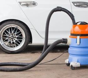the 6 best shop vacs to clean up messy projects, Blue and orange shop vac next to a white car Photo via Shutterstock