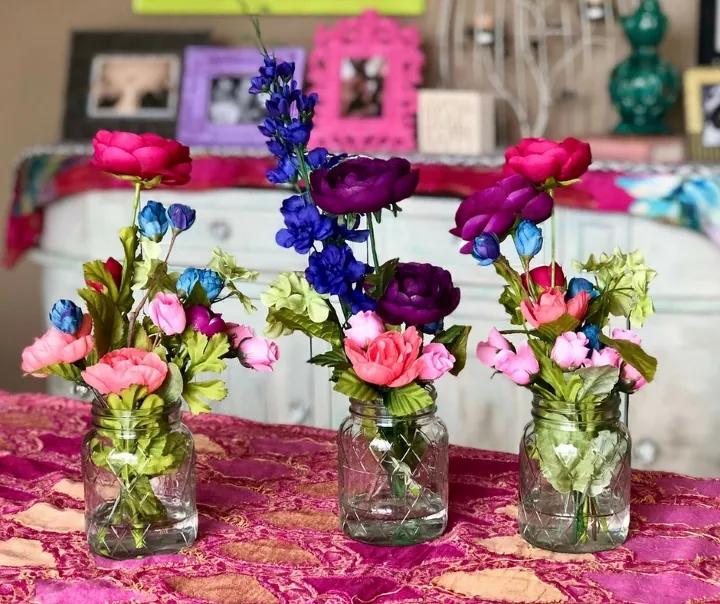 how to make artificial flower arrangements look more realistic, three faux flower arrangements in mason jars sitting on a table