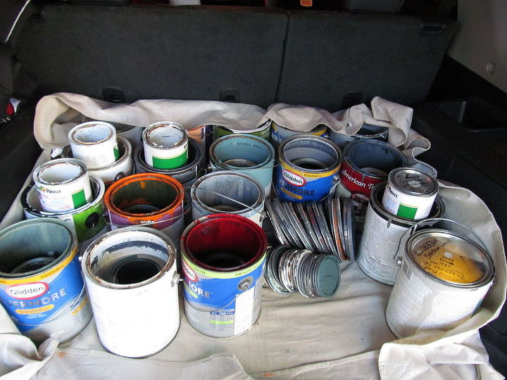 how to dispose of paint, several paint cans on drop cloth