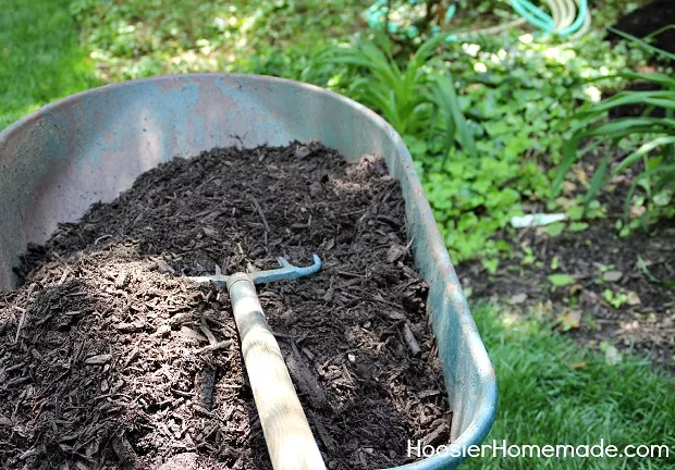 Wheelbarrow filled with brown mulch / Photo via Hoosier Homemade