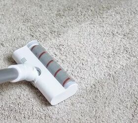 how to clean a vacuum, gray and white stick vacuum over white carpet