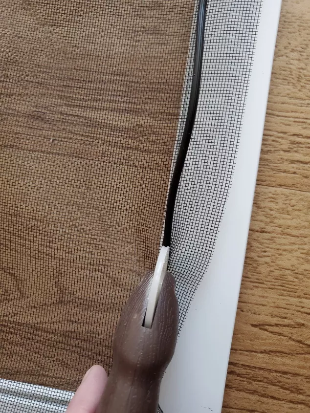 how to repair a window screen with tears and holes, screen rolling tool securing spline and screen to window frame