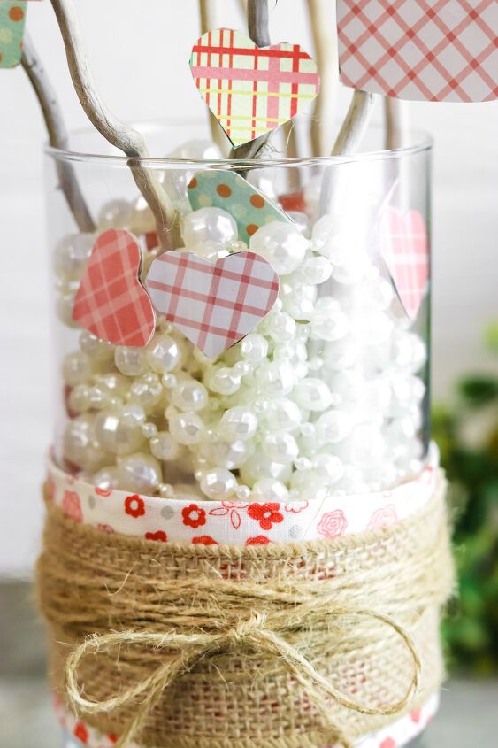 , I absolutely love the look of the hearts tucked in among the beads too And gluing them to the outside of the vase is a special touch