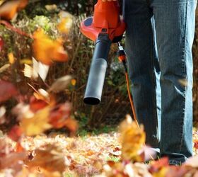 the 7 best leaf blowers for yards of every size, person holding leaf blower to blow leaves Photo via Shutterstock