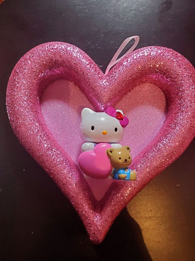 5 minute diy valentine s day hello kitty heart wreath, Gluing the cute plastic Hello Kitty Figurine
