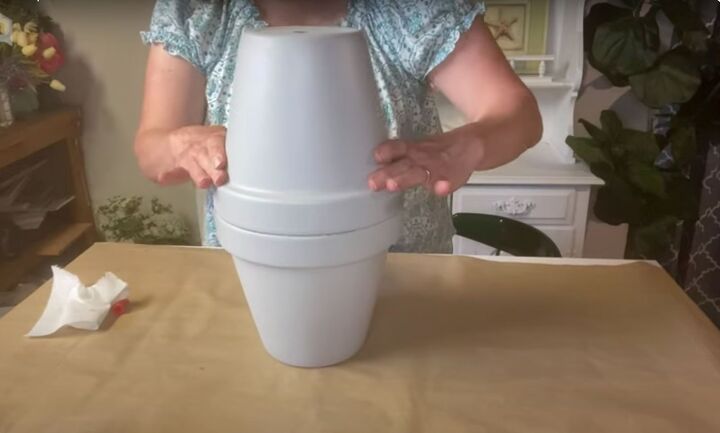 this cute diy birdbath is guaranteed to attract a few feathered friend, Placing one flowerpot on top of the other to form a base for the Simple DIY birdbath